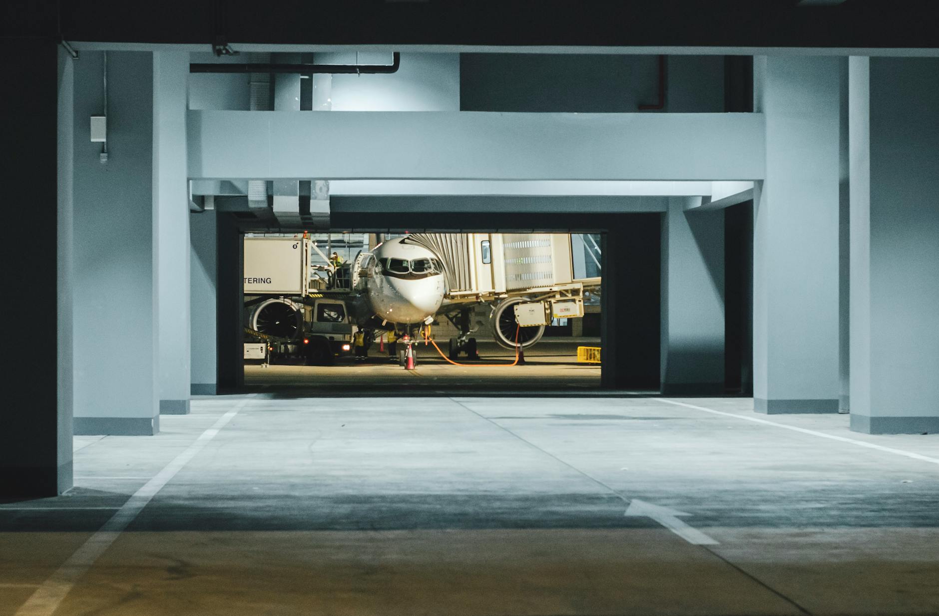 Airplane parked at night in a modern airport terminal gate in Angola.