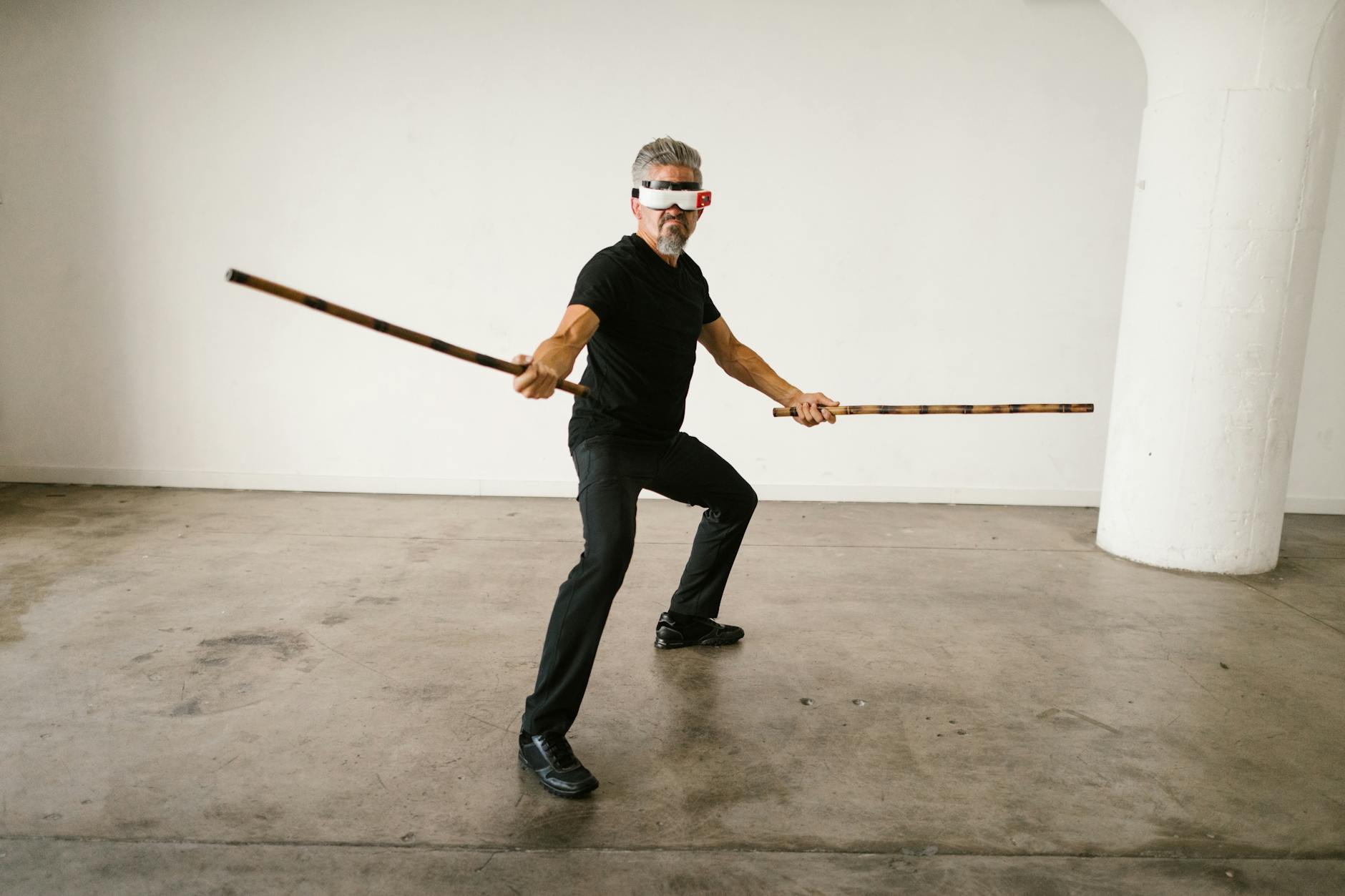 Futuristic martial arts training with virtual reality headset indoors.