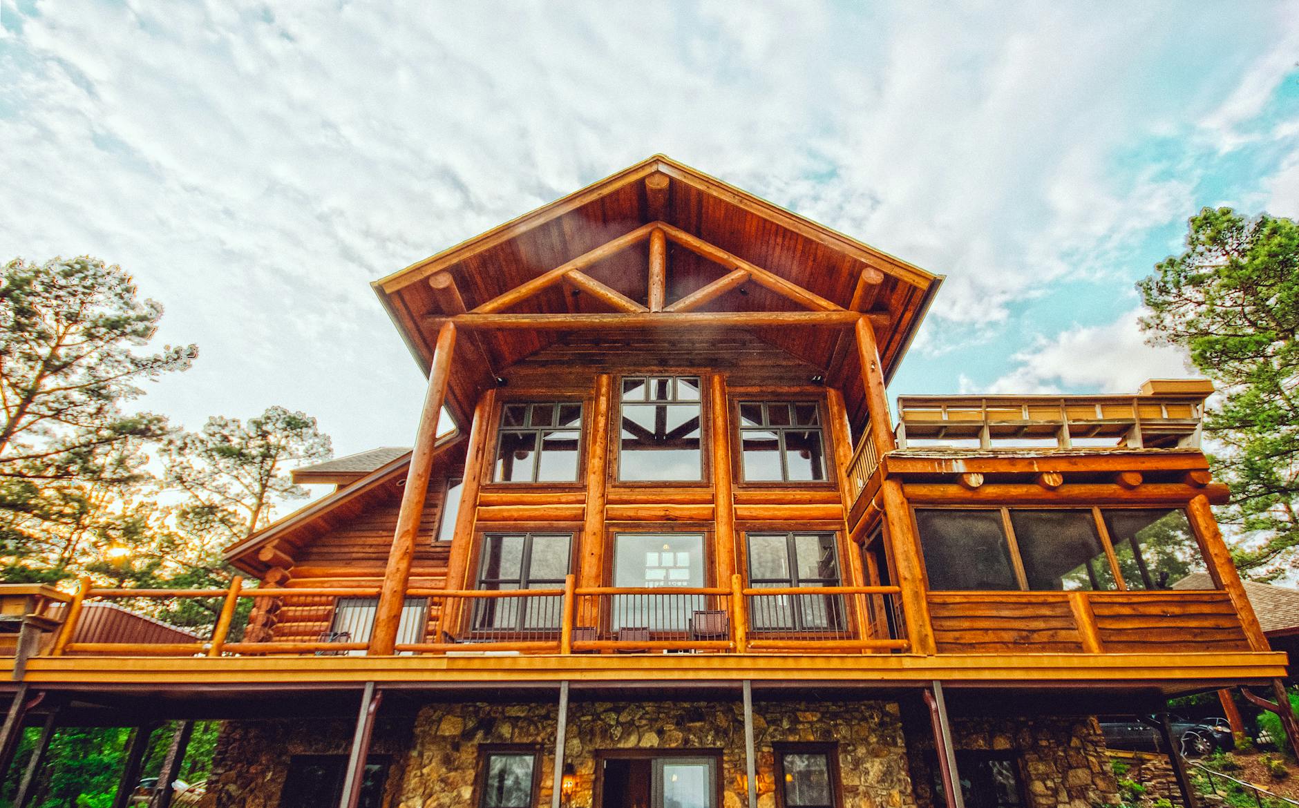 A stunning log cabin with exposed logs and glass windows showcasing natural beauty.