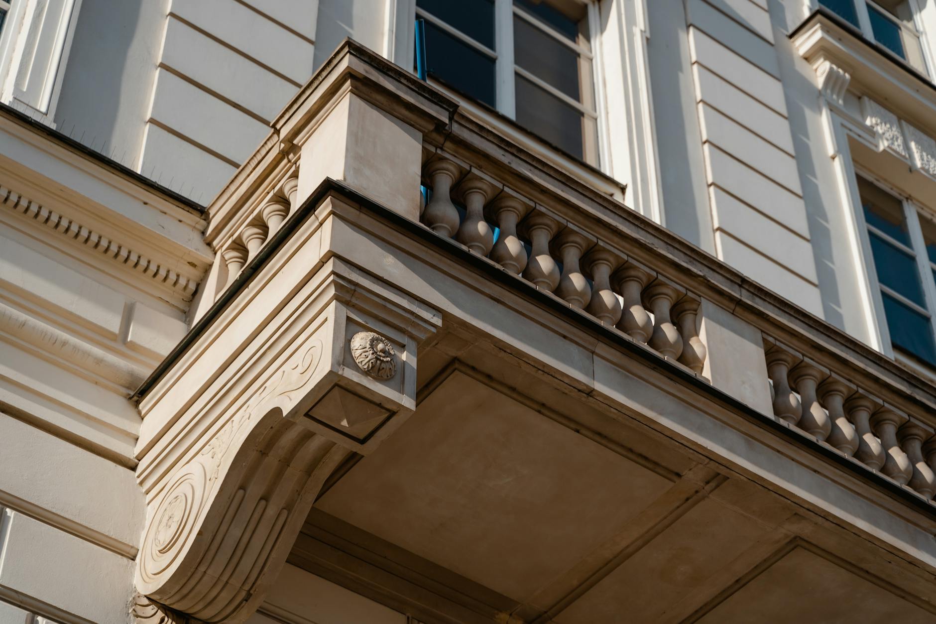Low-angle view of a classical building facade showcasing intricate architectural details.