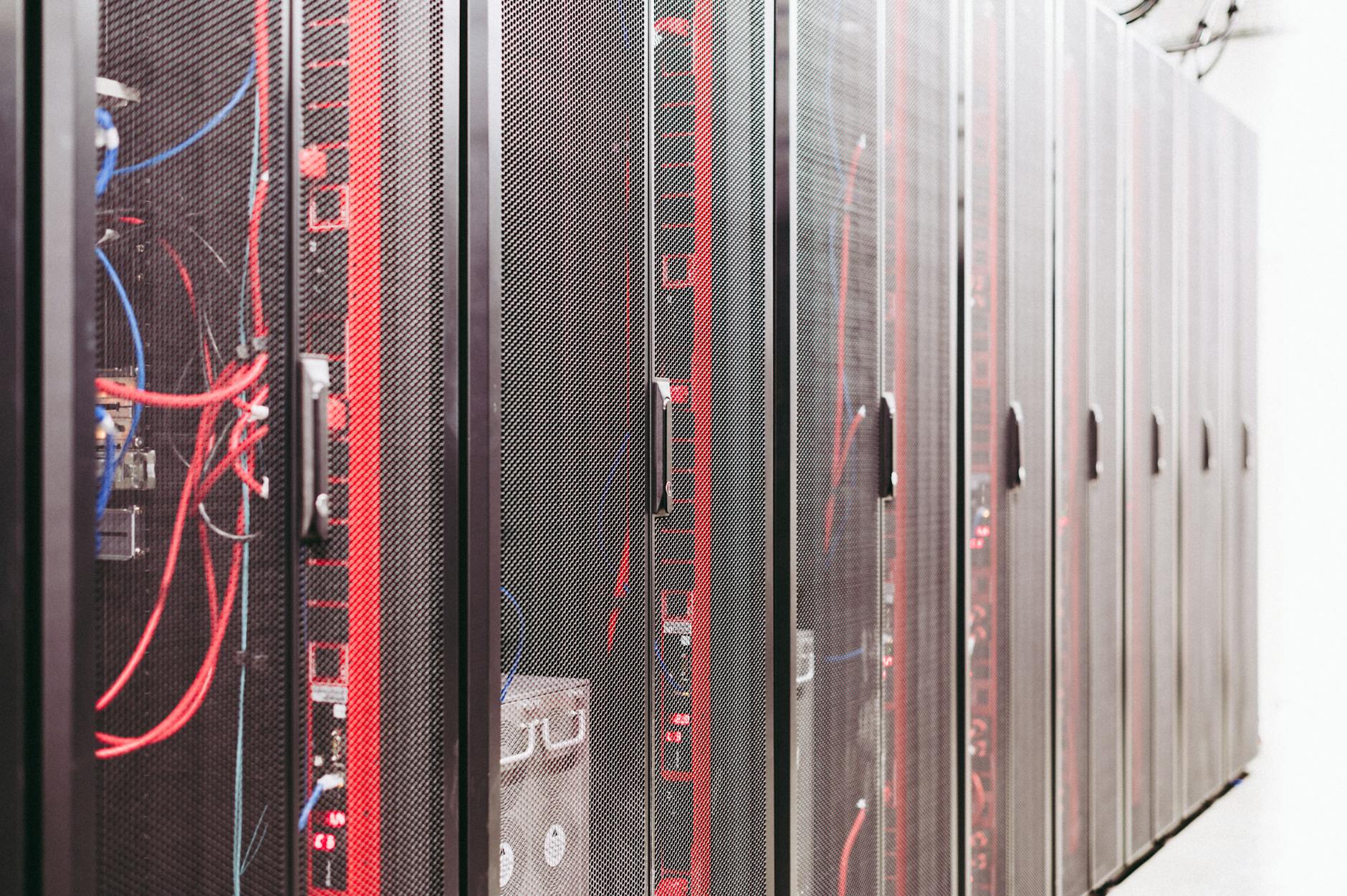 Modern data server room with network racks and cables.